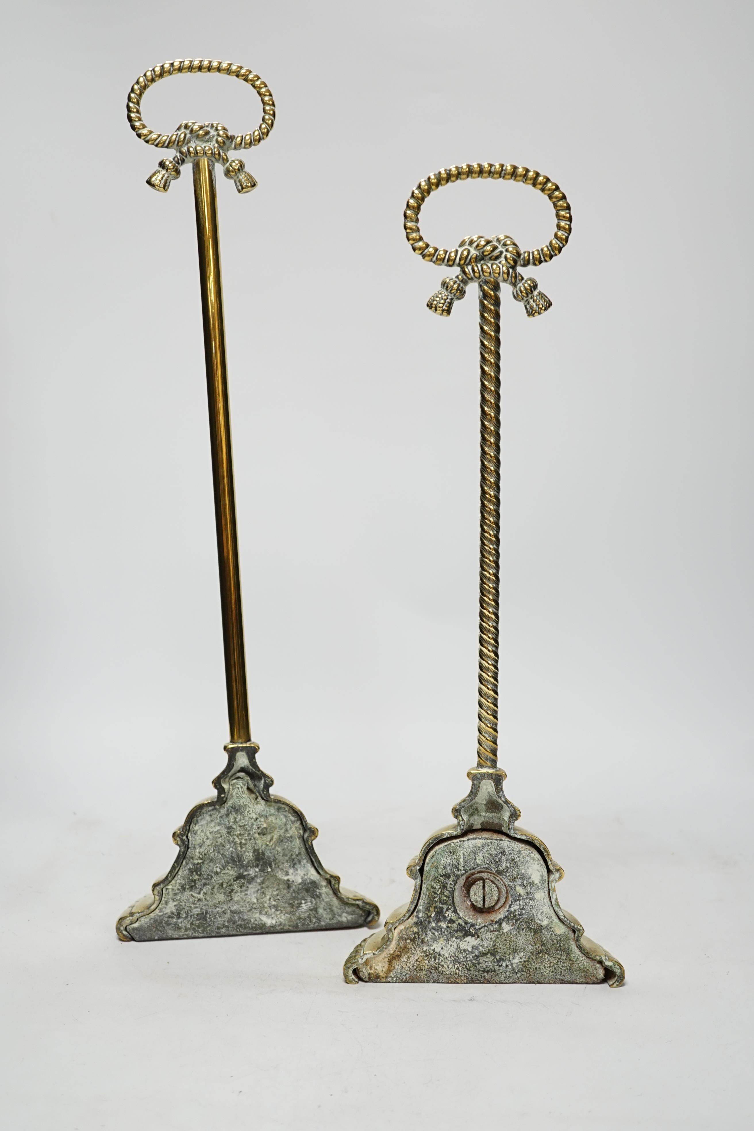 Two early 19th century cast brass door stops, with gadrooned edged plinths, tallest 50cm high